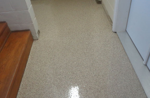This image shows a Basement Floor with flake epoxy paint.