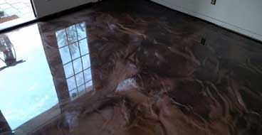 This image shows an living room with metallic epoxy floor.