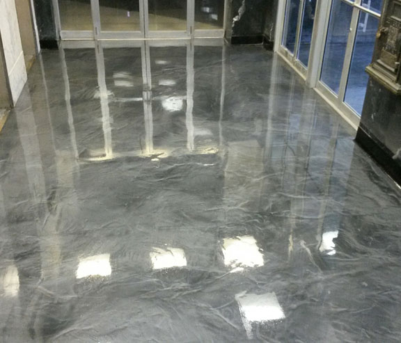 This image shows a commercial space with gray metallic epoxy floor.