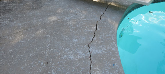 This image shows a cracked pool deck.