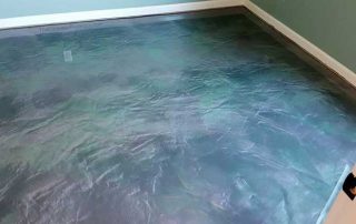 This image shows an living room with metallic epoxy floor.