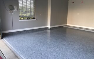 This image shows a garage floor with epoxy flooring paint.