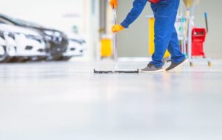 This image shows a man mopping an epoxy floor.